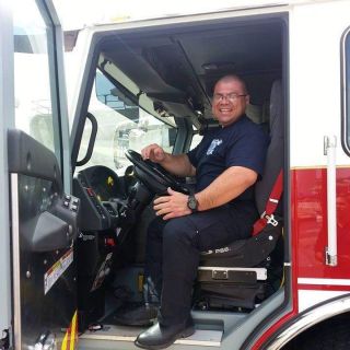 Photo of Cpl. Williams in fire truck 