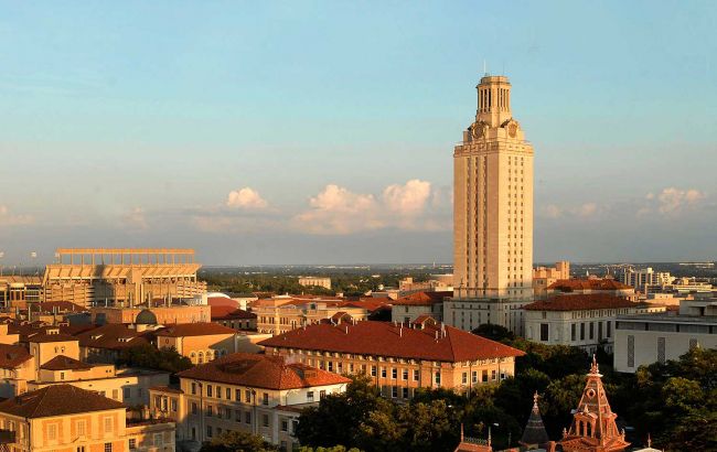 Wide shot of the UT Austin Tower and surrounding buildings at sunset