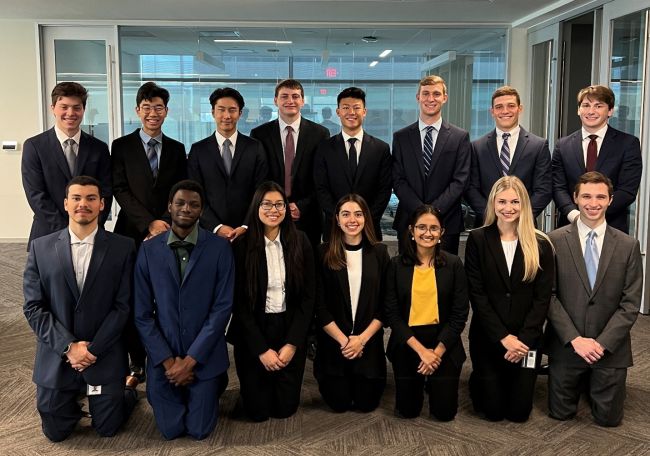 Group photo of Growing Investment Leaders interns, in two rows dressed in business attire and smiling