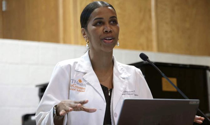 LaTanya Love speaking at a podium