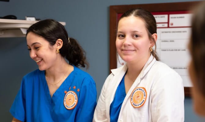 Two nurses in a clinical setting.