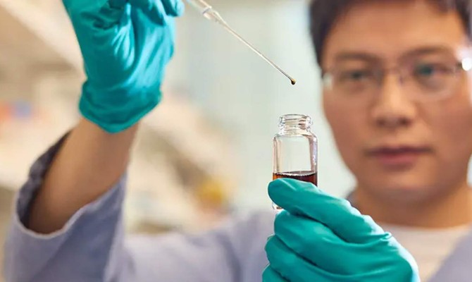 Individual holding Ibogaine dropper in lab