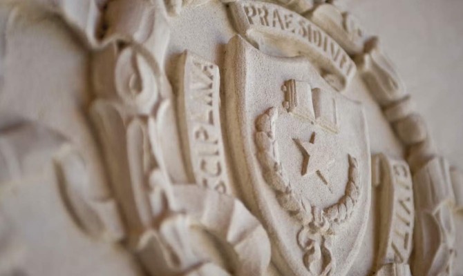 The University of Texas at Austin shield carved in a building exterior