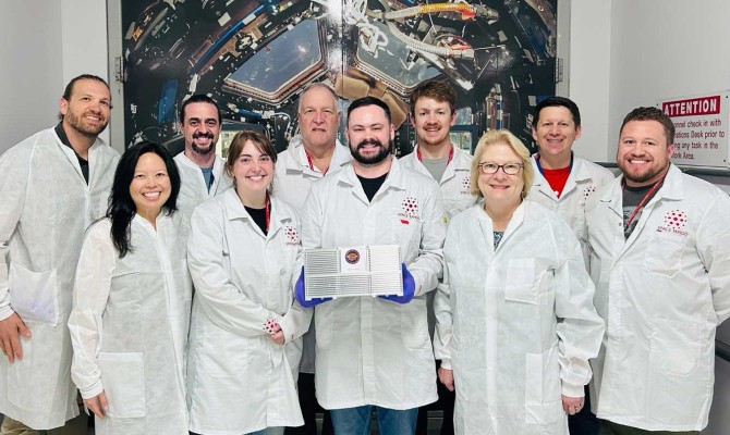 Members of the VIBES project team holding up their research experiement