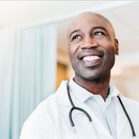 smiling doctor in lab coat