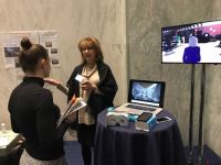 Leanne Young from the UT Dallas Center for BrainHealth demos a virtual reality program that teaches social skills to autistic kids at the research showcase.  