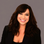 A professional head shot of Lauran Hartmann, smiling